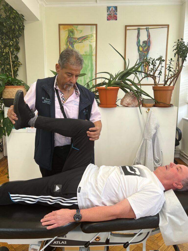 Chiropractor assessing knee pain at Bedford Chiropractic Clinic, focusing on personalized treatment and mobility improvement.